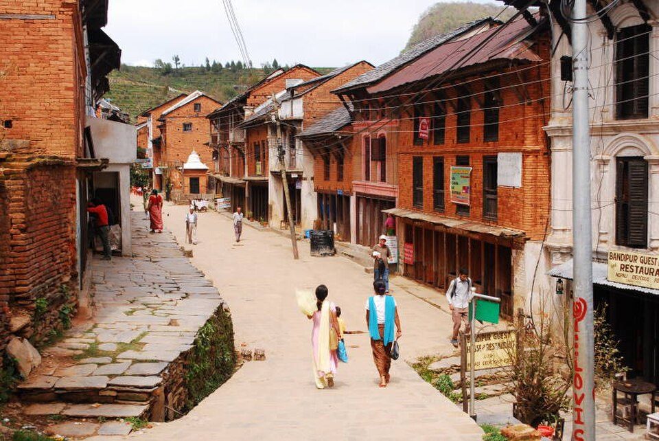 Residents walking the bazaar between traditional Newar houses